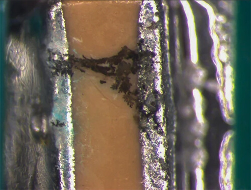 Dendritic grown between solder pads, caused by ionic contamination (photo courtesy of Foresite)